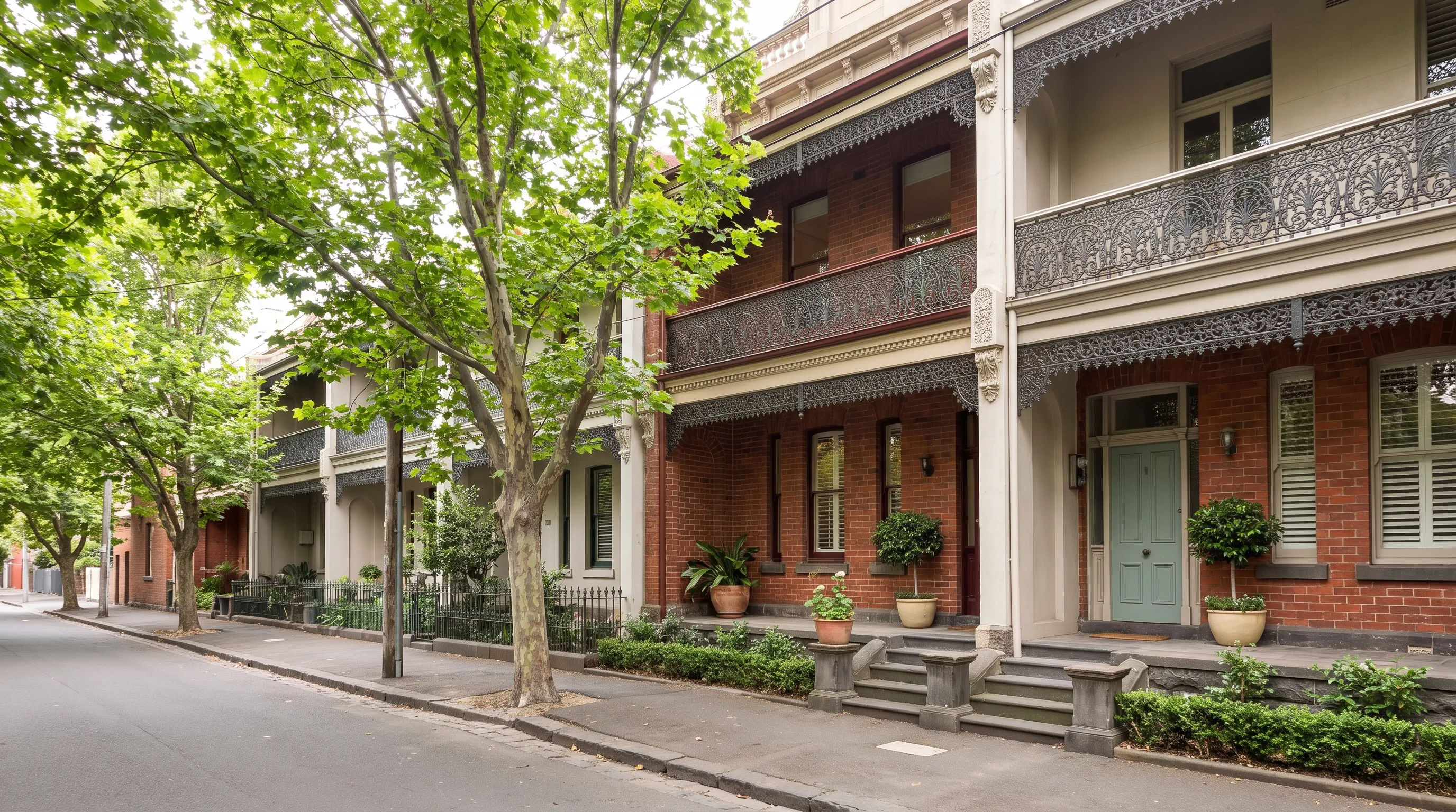 A row of Melbourne Victorian terrace houses with iron-lace verandahs